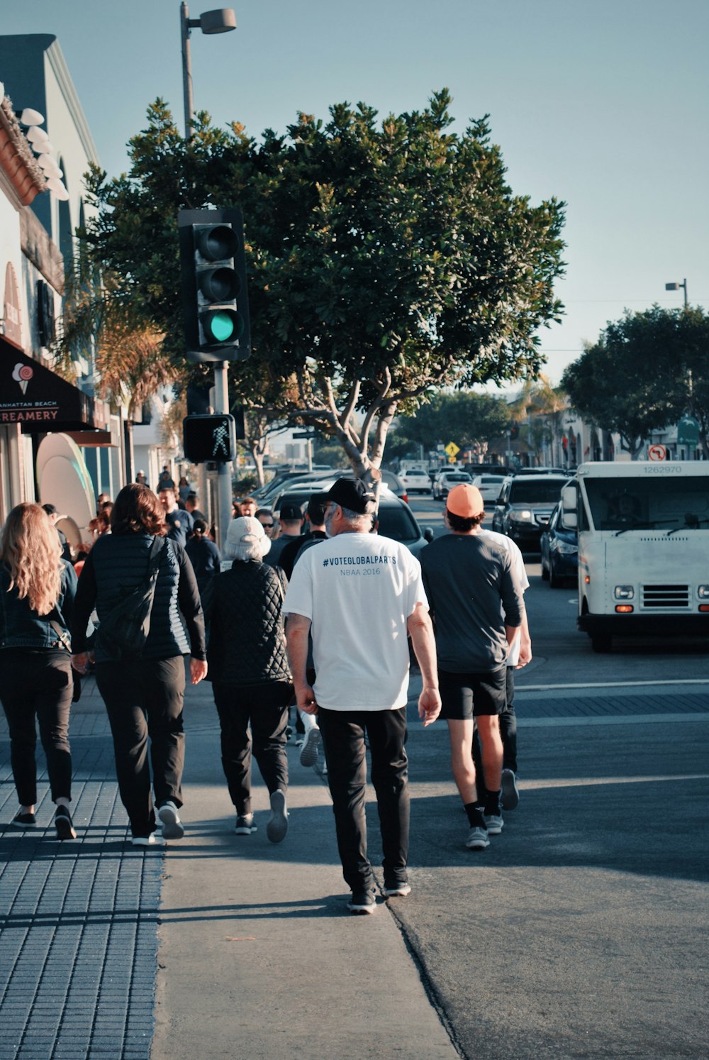 people walking near traffic light during daytime