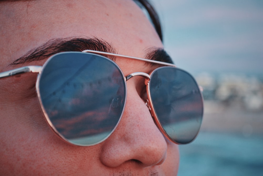 person wearing silver-framed Aviator-style sunglasses