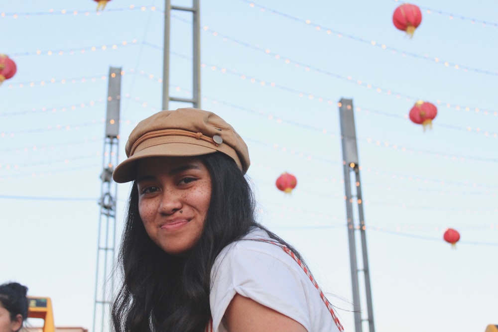 smirking woman wearing brown hat