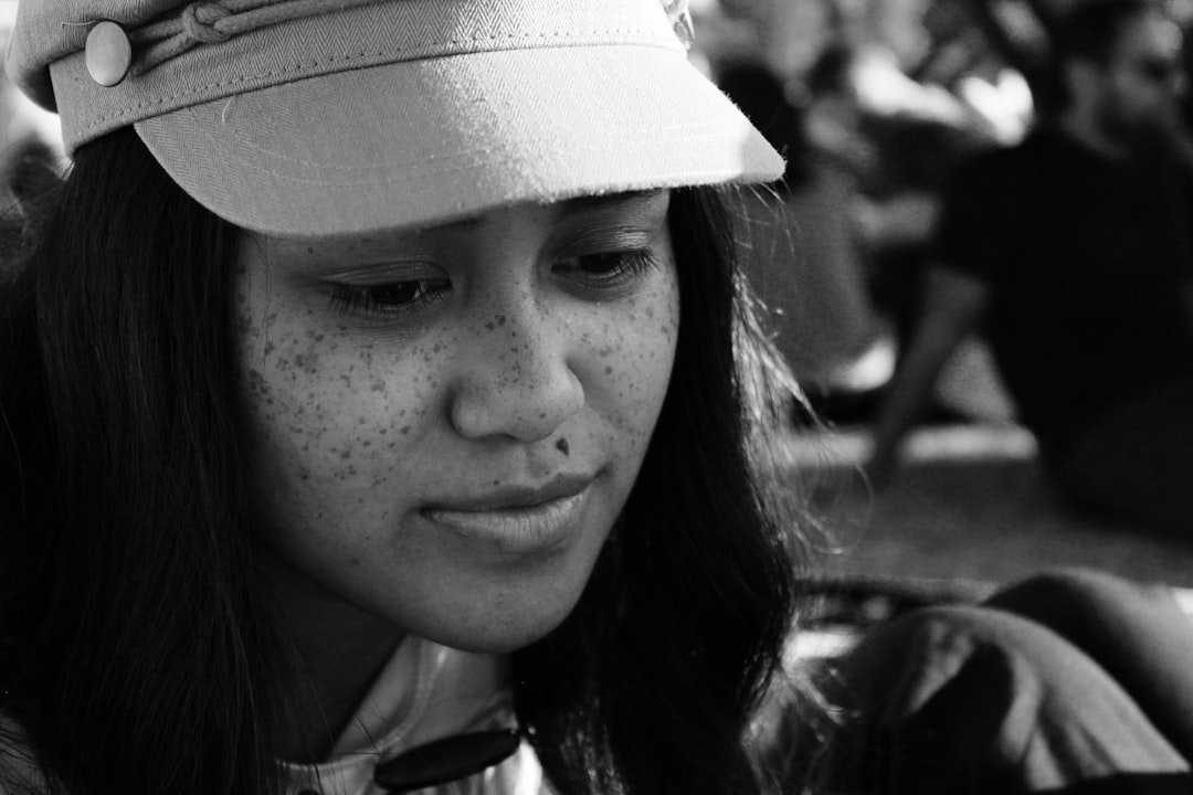 grayscale photo of woman wearing hat