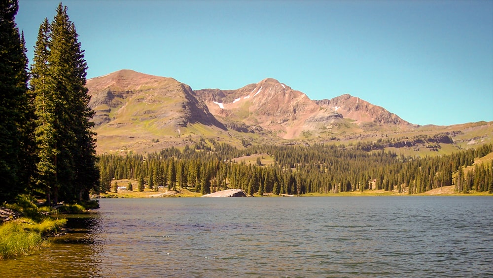 a lake with mountains in the background