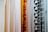 A variety of fabric panels hanging side by side, showcasing different patterns and colors. The fabrics include solid colors, stripes, geometric patterns, and abstract designs.
