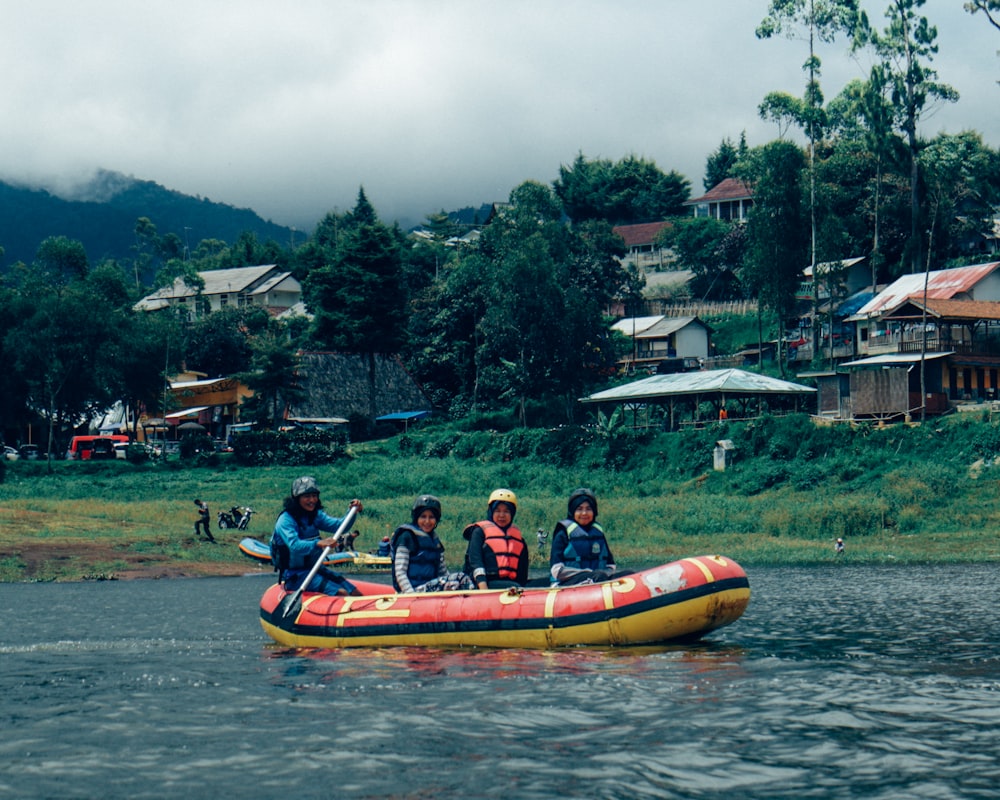 four people riding on inflatable raft boat