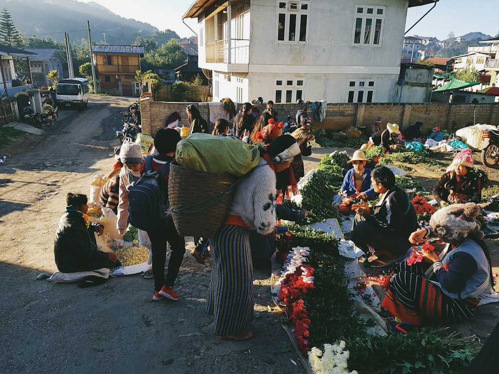 group of people selling vegetable during daytime