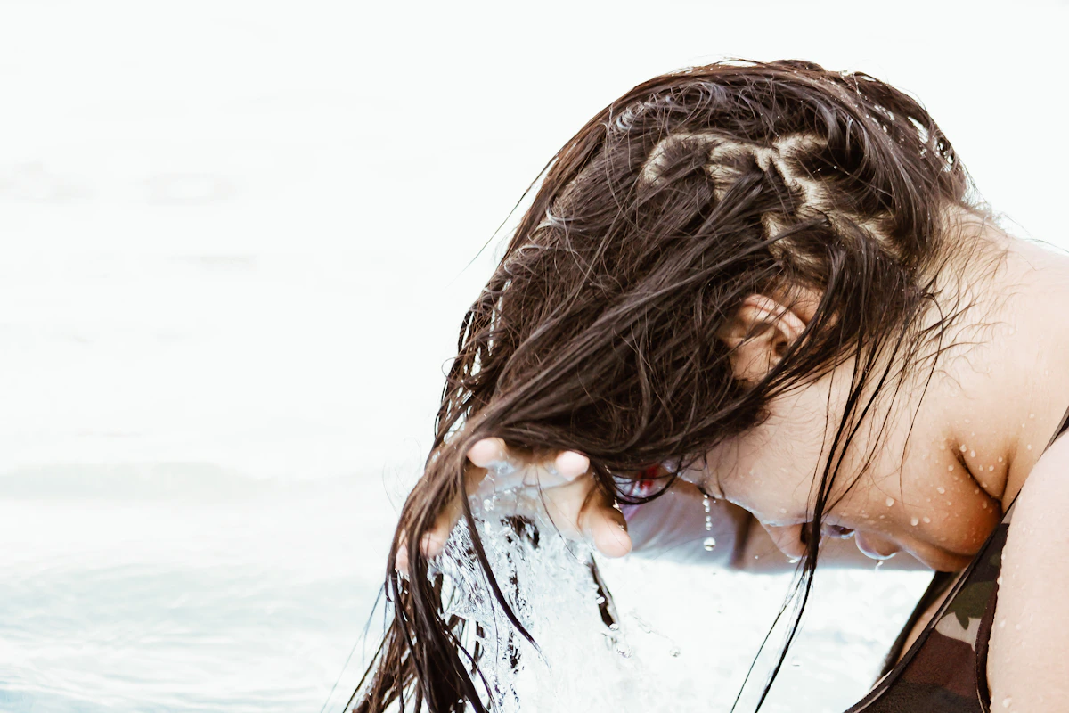 Hands caring for natural, textured hair
