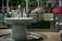 A happy customer standing beside a beautiful marble fountain.