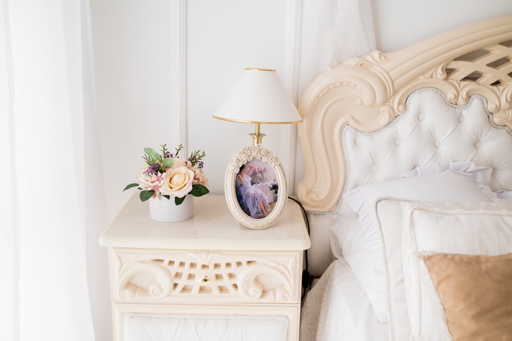 white table lamp on top of white nightstand