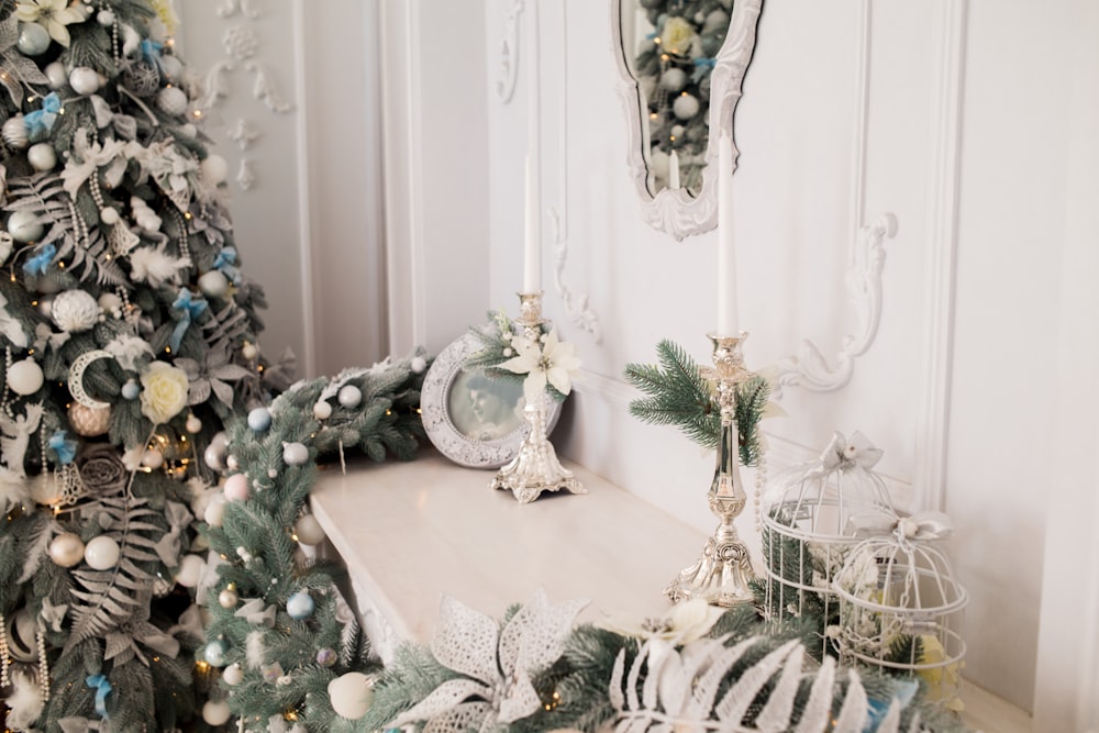 green Christmas tree beside white wall