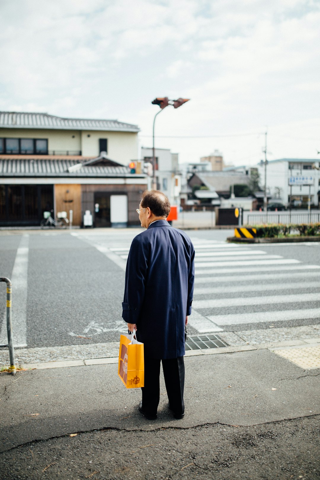 man standing beside road