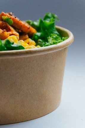 A close-up of a colorful salad bowl with fresh vegetables and herbs.