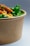 A close-up of a fresh green salad bowl with vibrant vegetables.