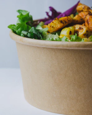 Close-up of a colorful protein-packed salad bowl with fresh vegetables and grilled chicken.