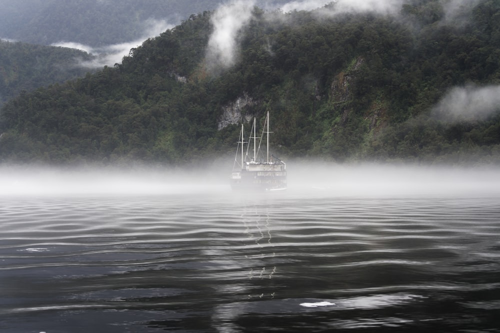 boat in body of water grayscale artwork