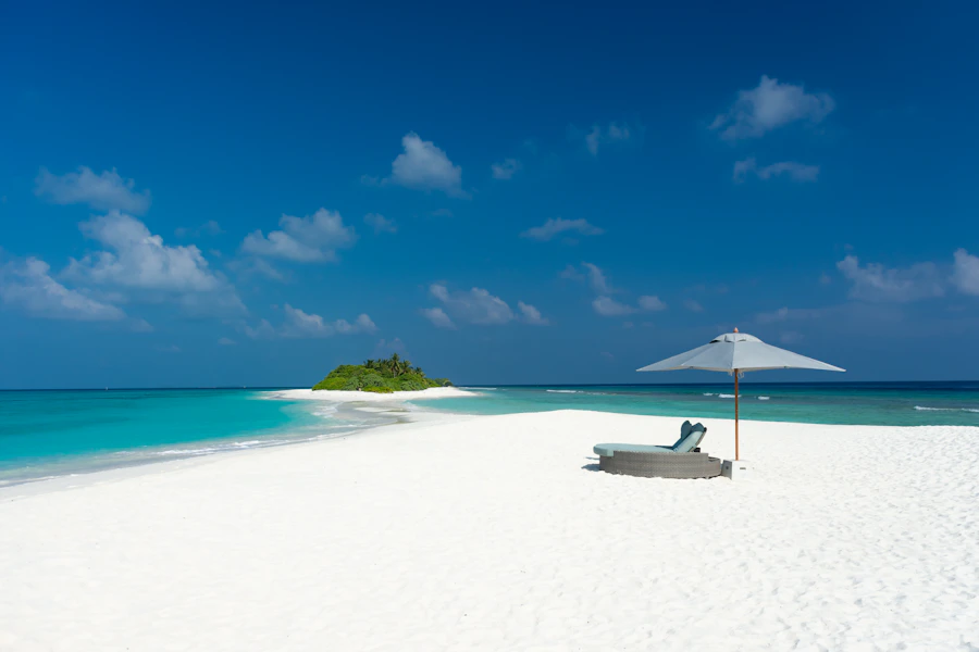 Bright white sand beside clear blue water