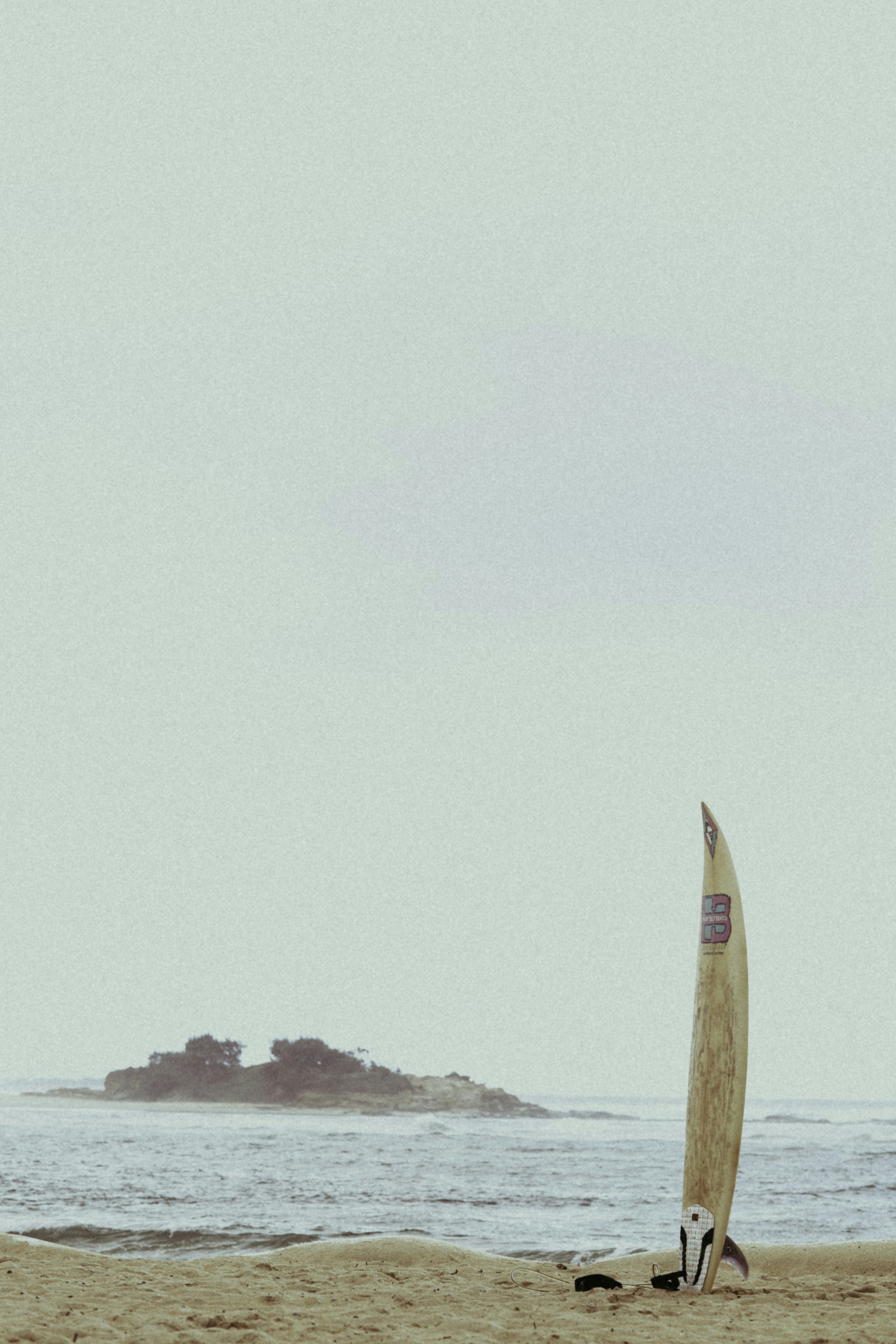 surfboard on white sand