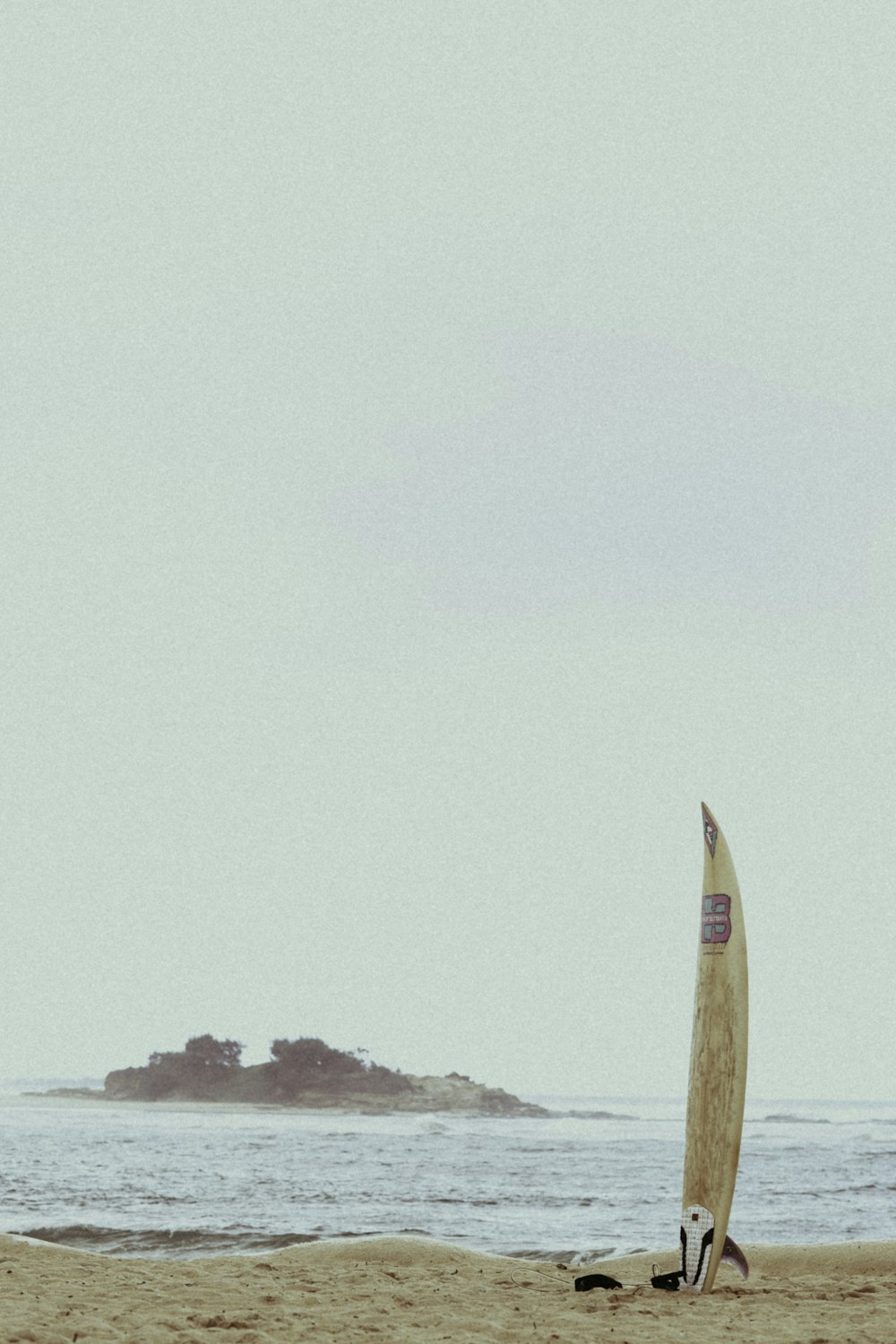 surfboard on white sand