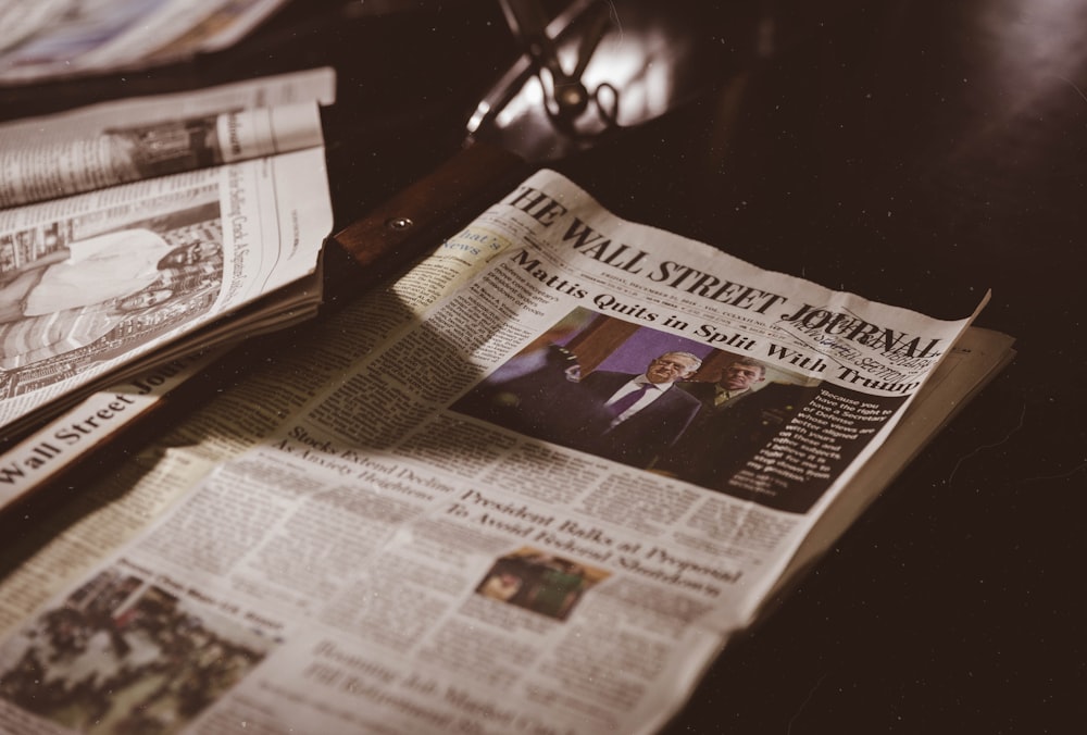 newspaper on black wooden table