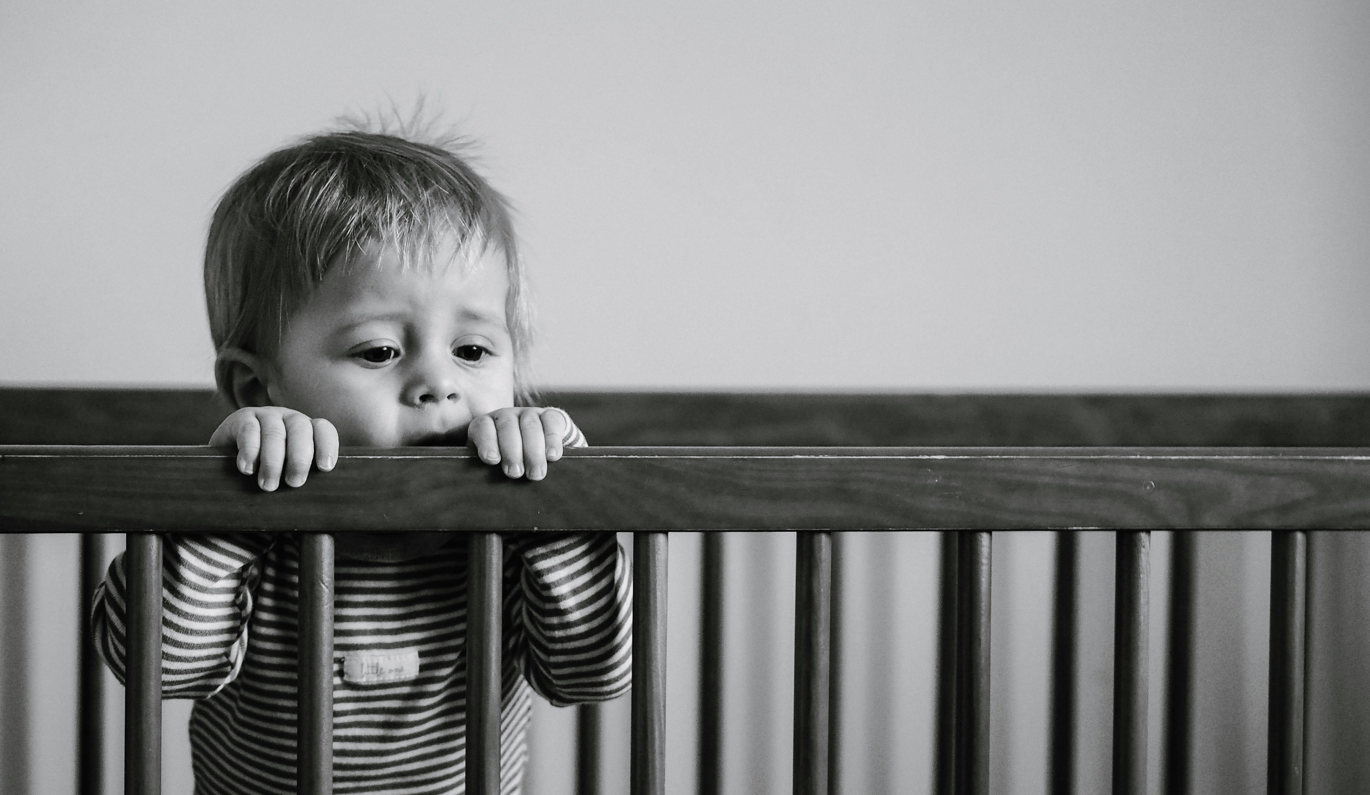 Grayscale Photography Of Baby Playing In Crib Photo Free Black