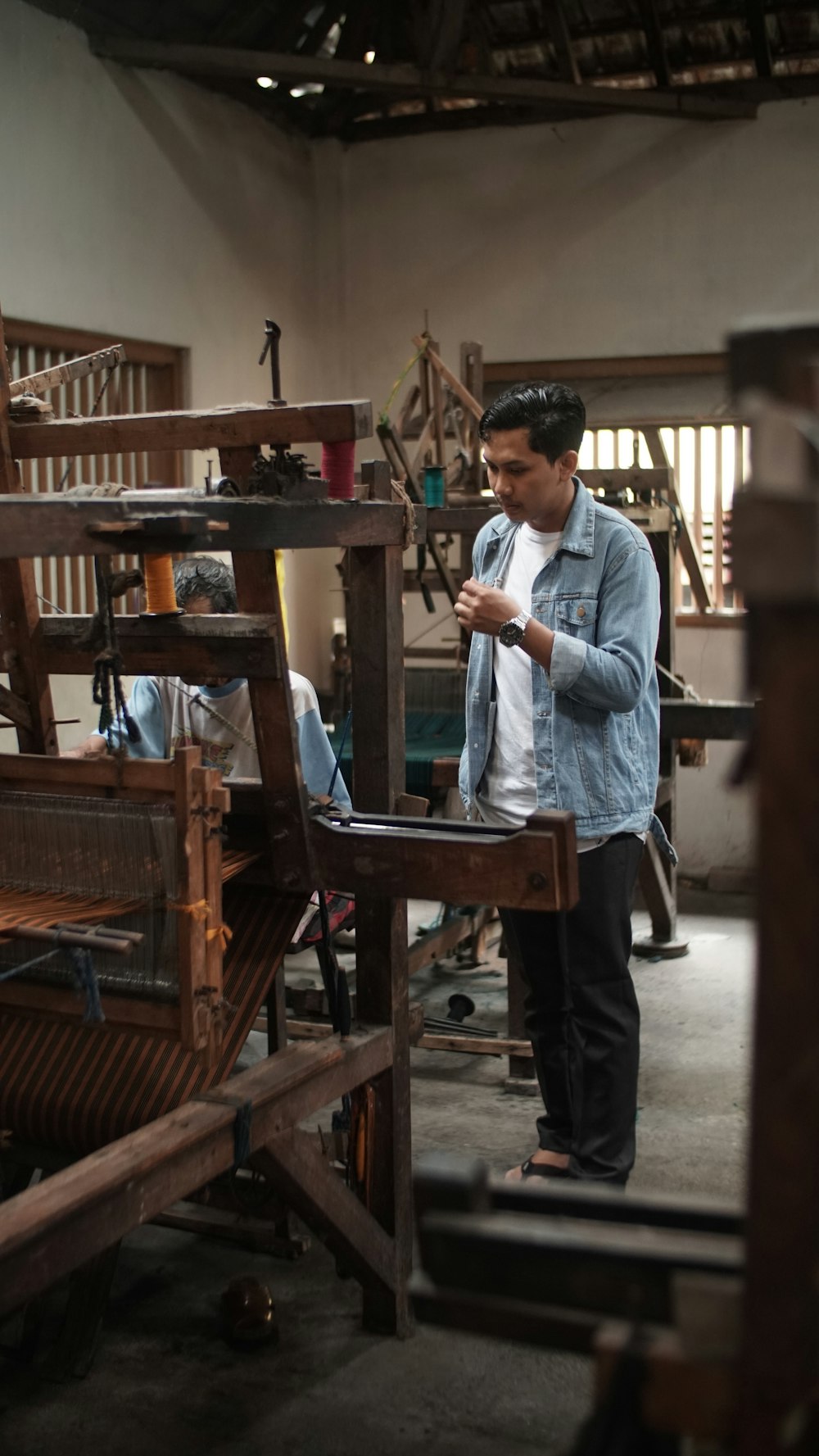 standing man looking at the weaving man