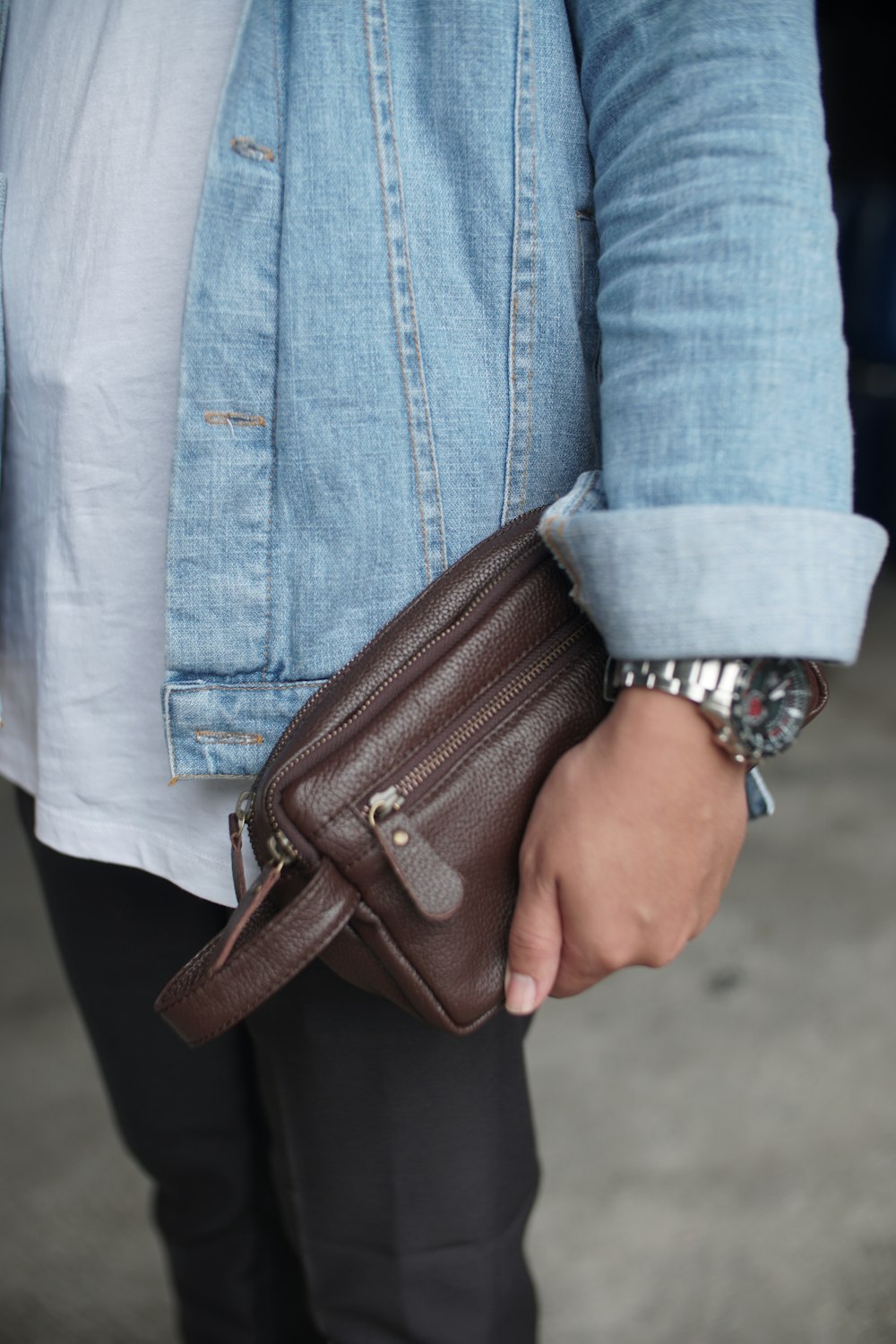 person carrying brown handbag