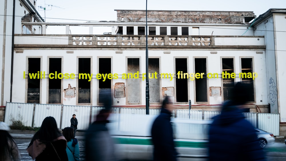 a blurry photo of people walking in front of a building