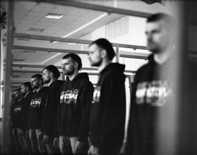 Veteran members standing proudly in traditional Memphis Misraim attire under soft lighting.