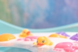 A cozy baby bath setup with colorful bath toys.