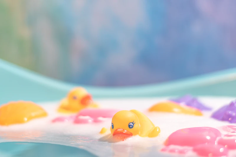 Cute baby splashing in bath water during bath time