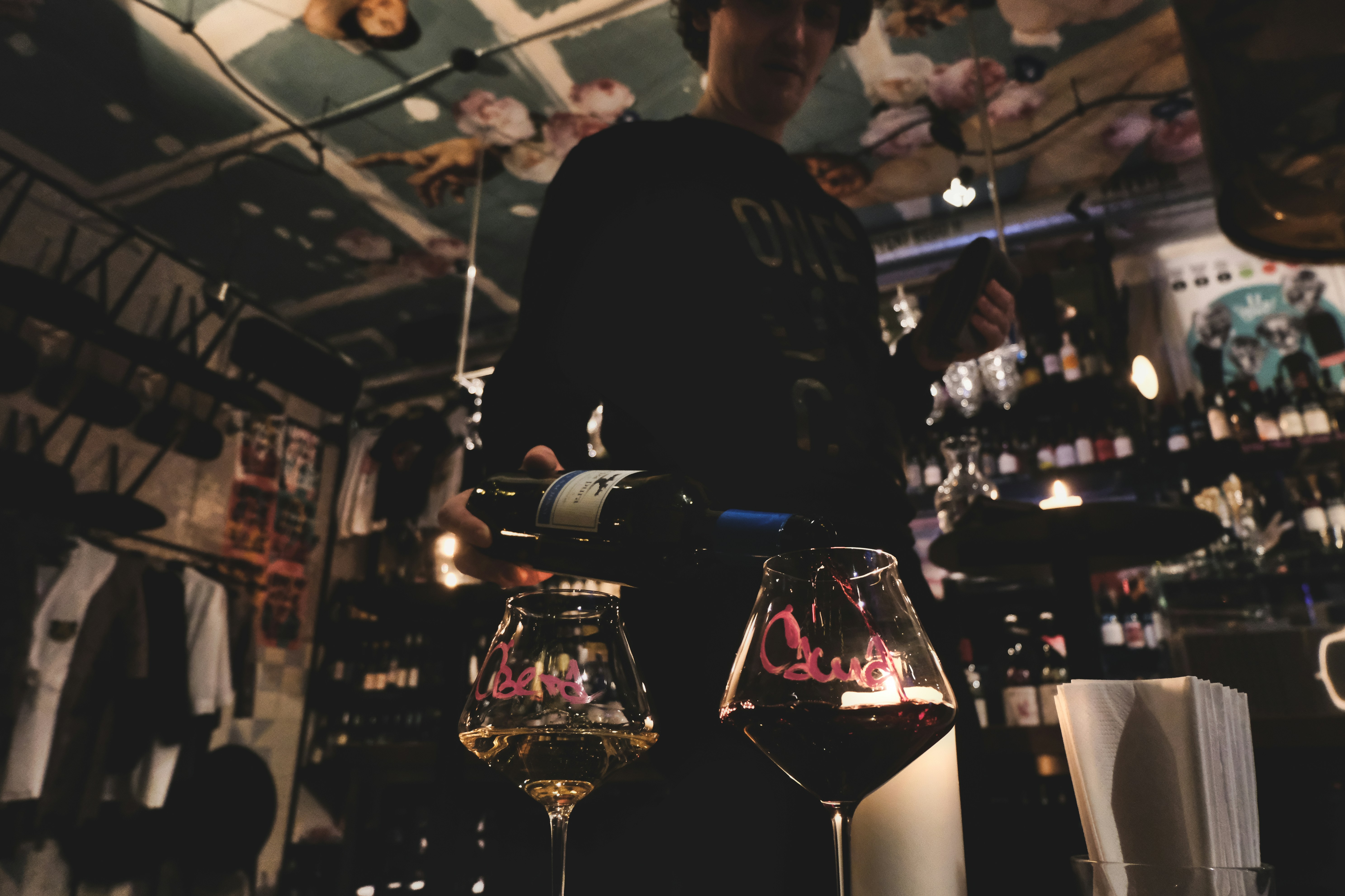 Woman pouring wine at a bar