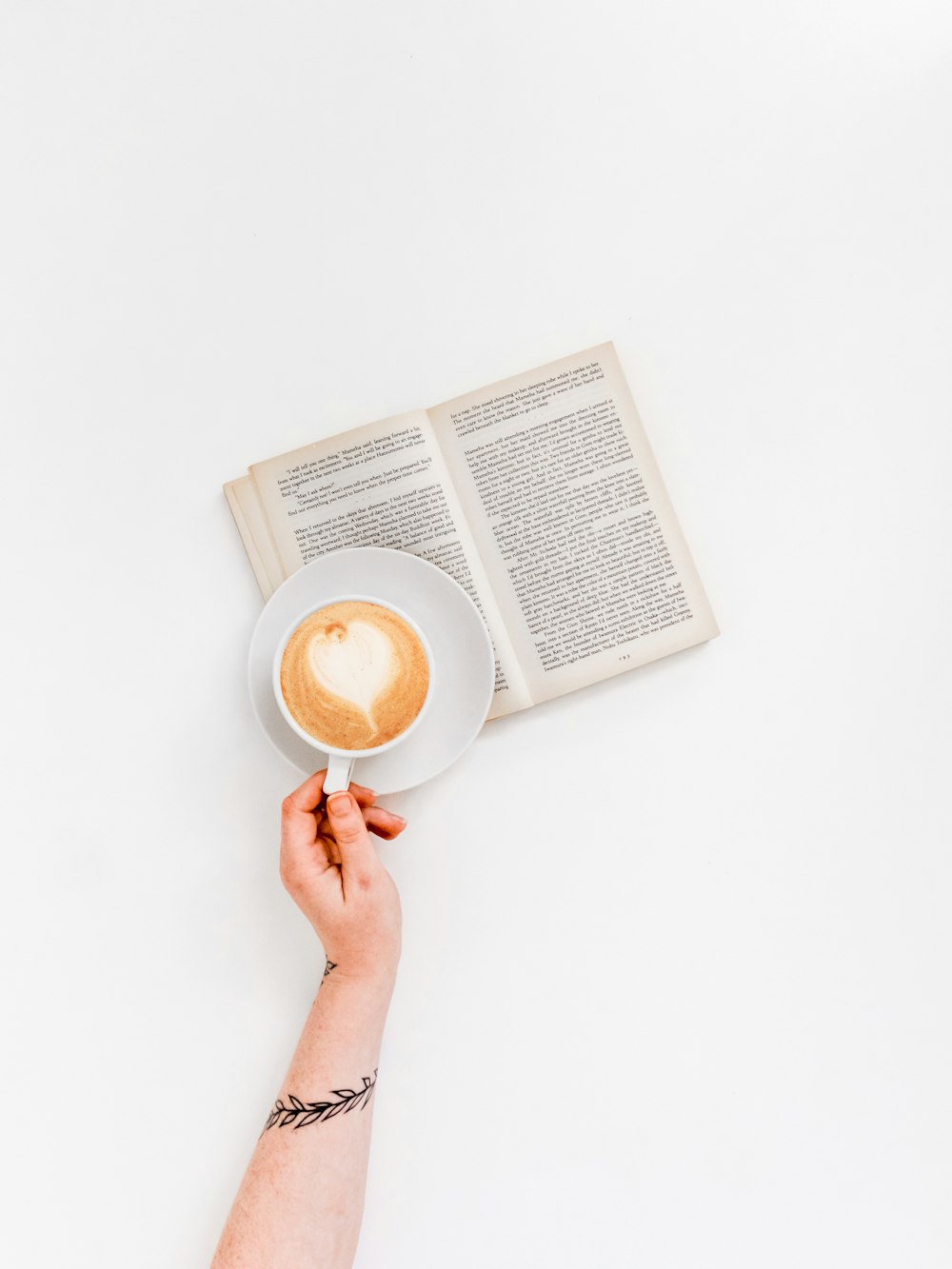 flat lay photo of coffee and book