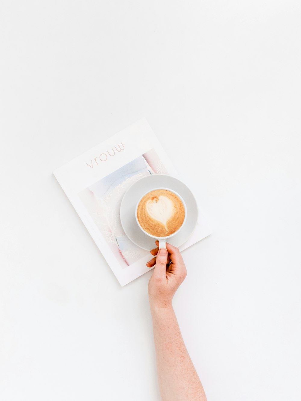 person holding white ceramic mug