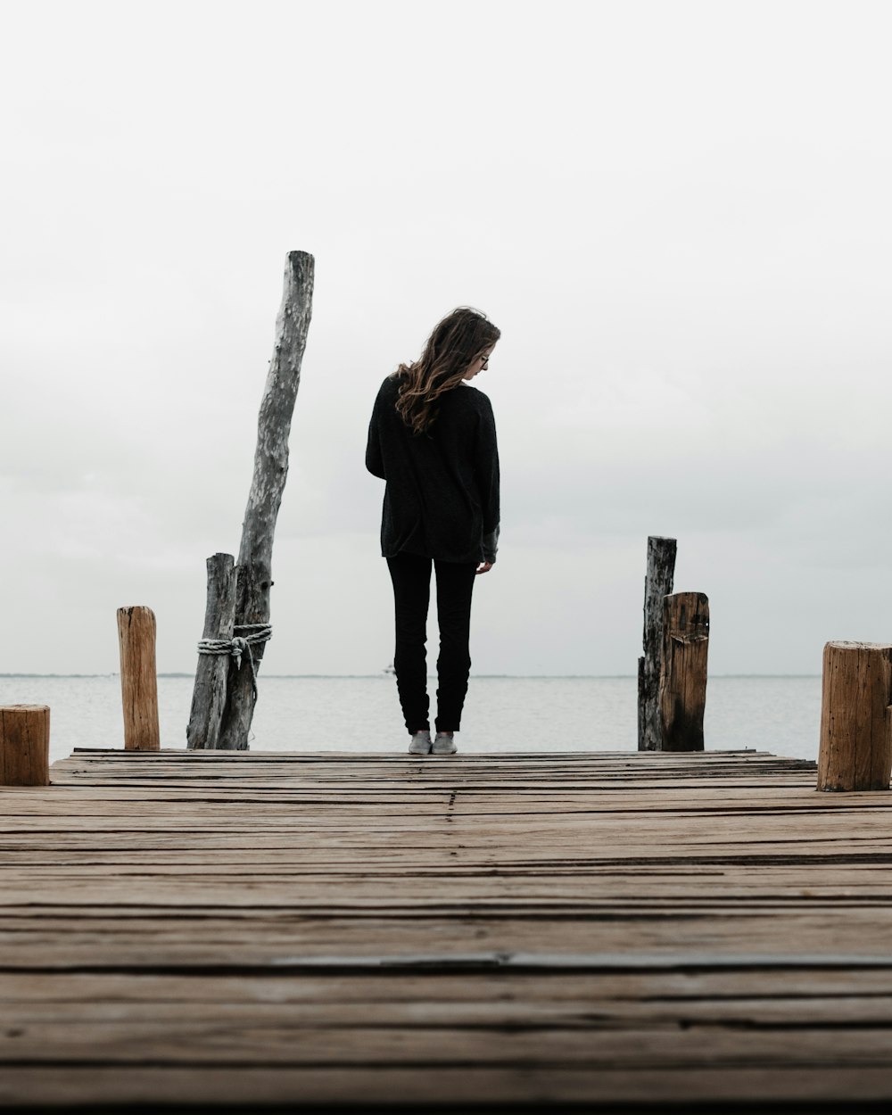 woman standing on wooden dock