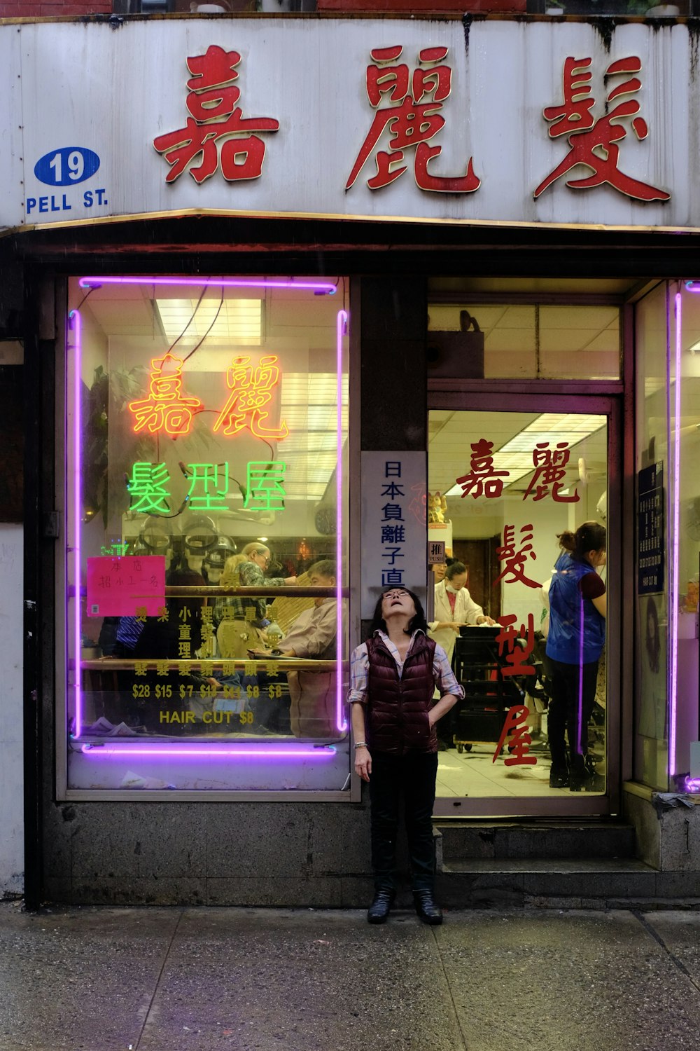 woman standing near signage and door