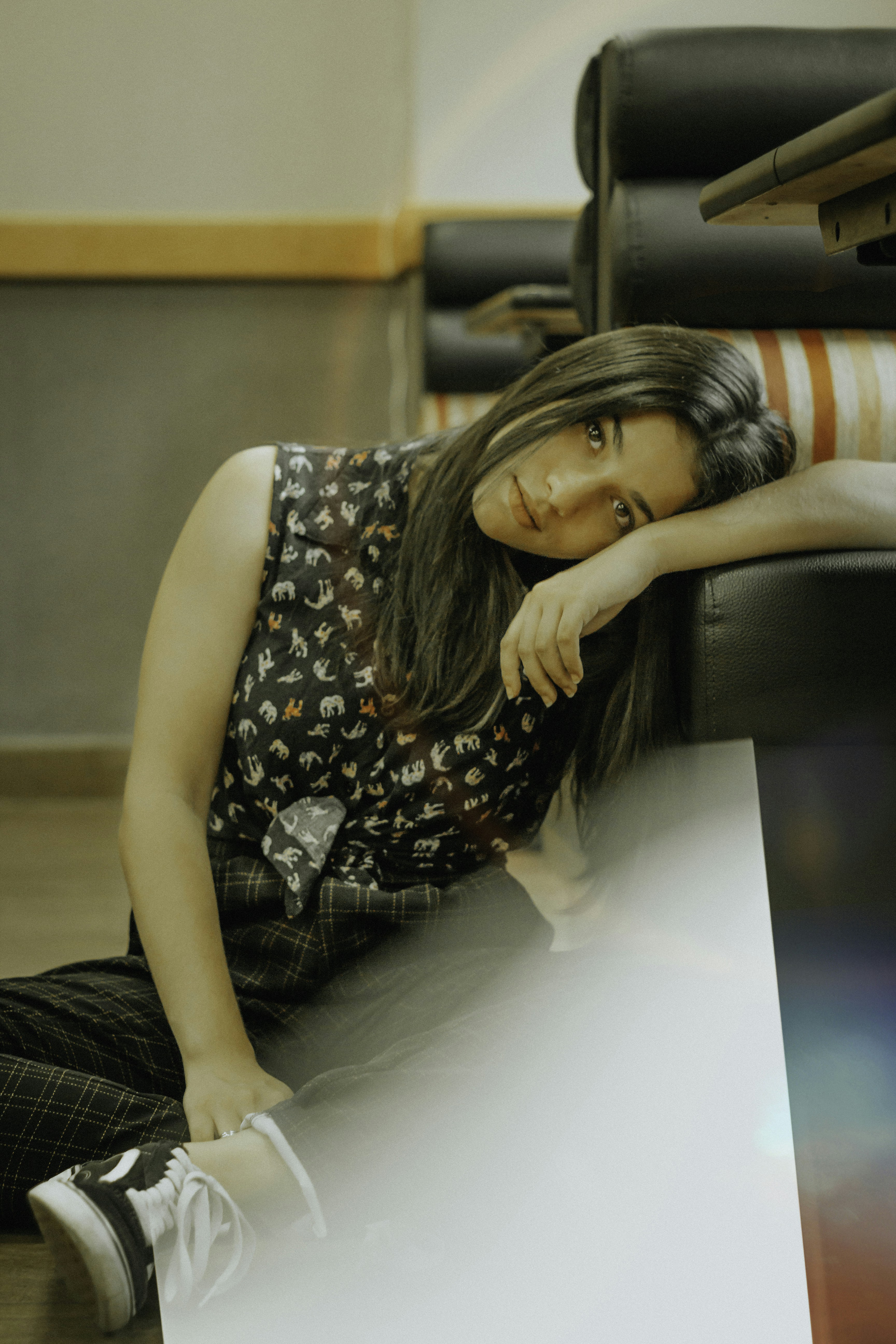 woman leaning on black sofa