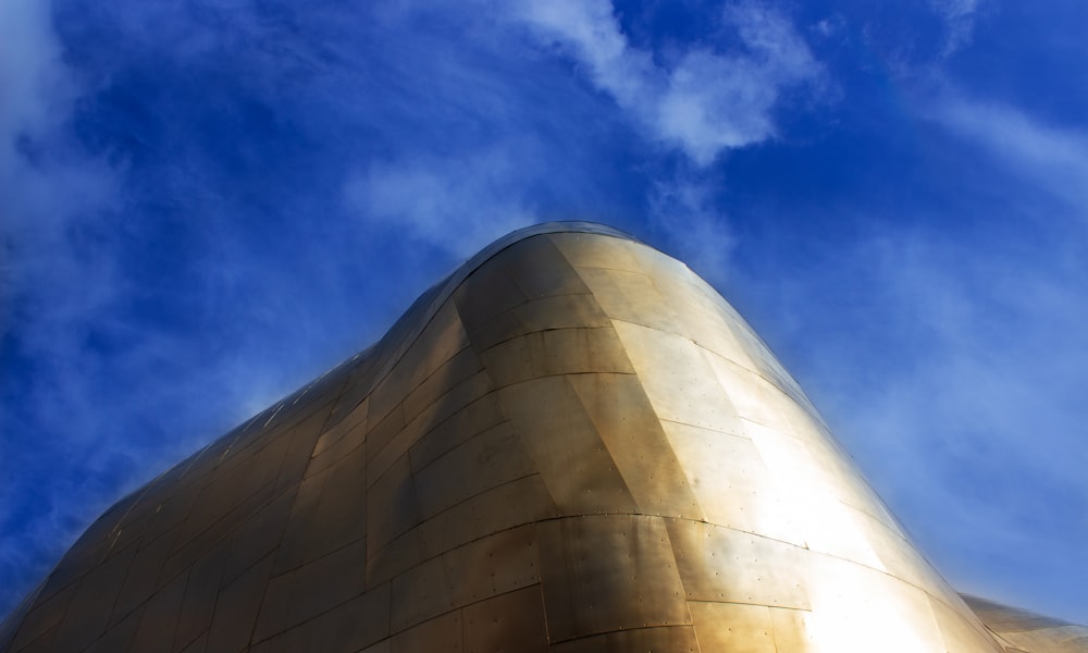 gold high-rise building under blue sky