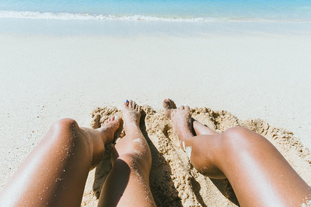 person legs near on seashore beach