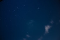 A whimsical illustration of stars and moons in a night sky.