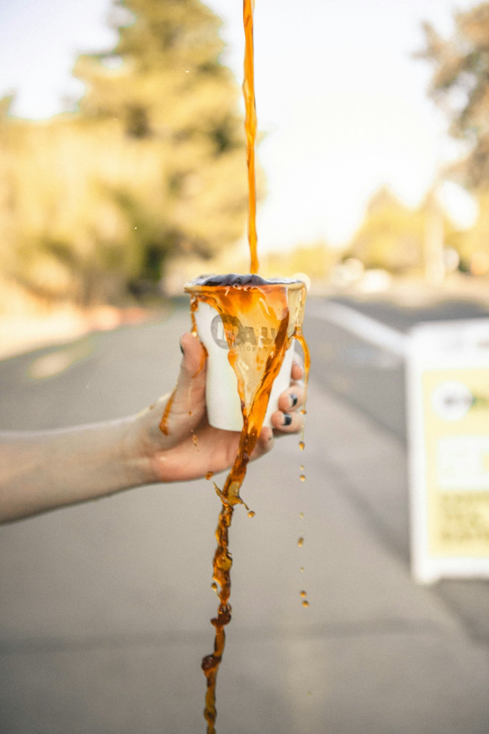 person holding overflowing cup