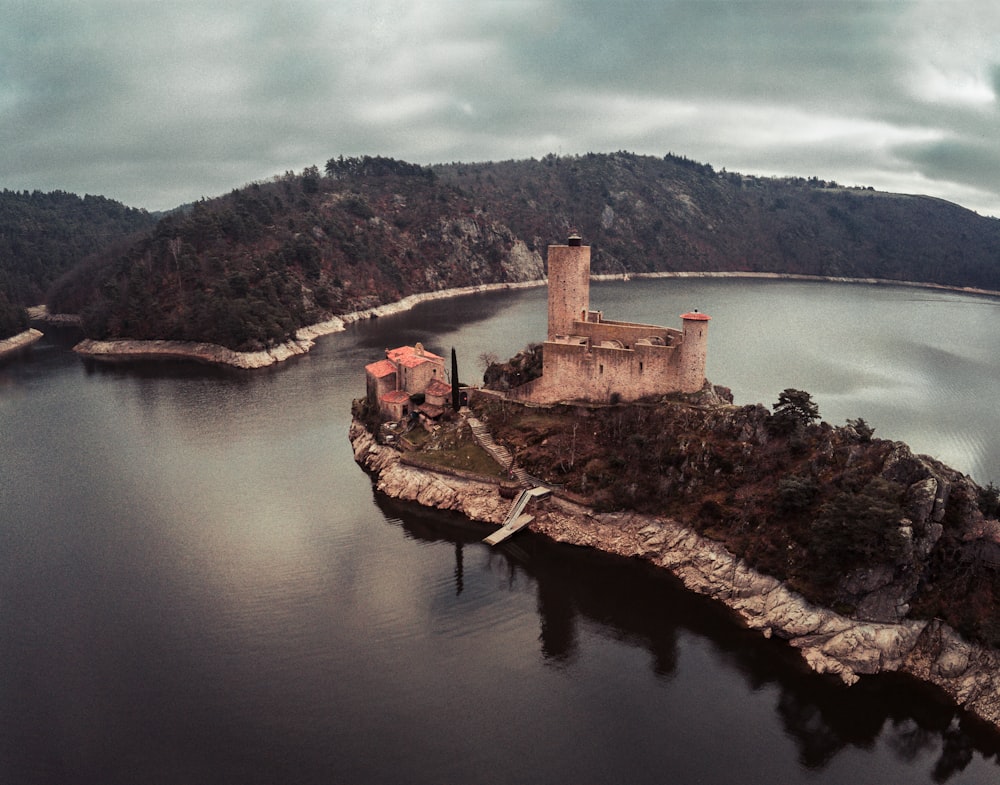 aerial photography of brown house beside body of water