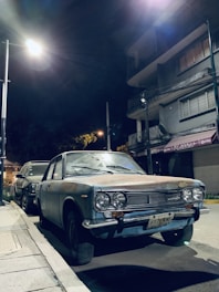 Image of a car parked on roadside using a glowing V16 beacon at dusk.