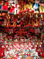 A colorful setup of plush toys at a festive event.