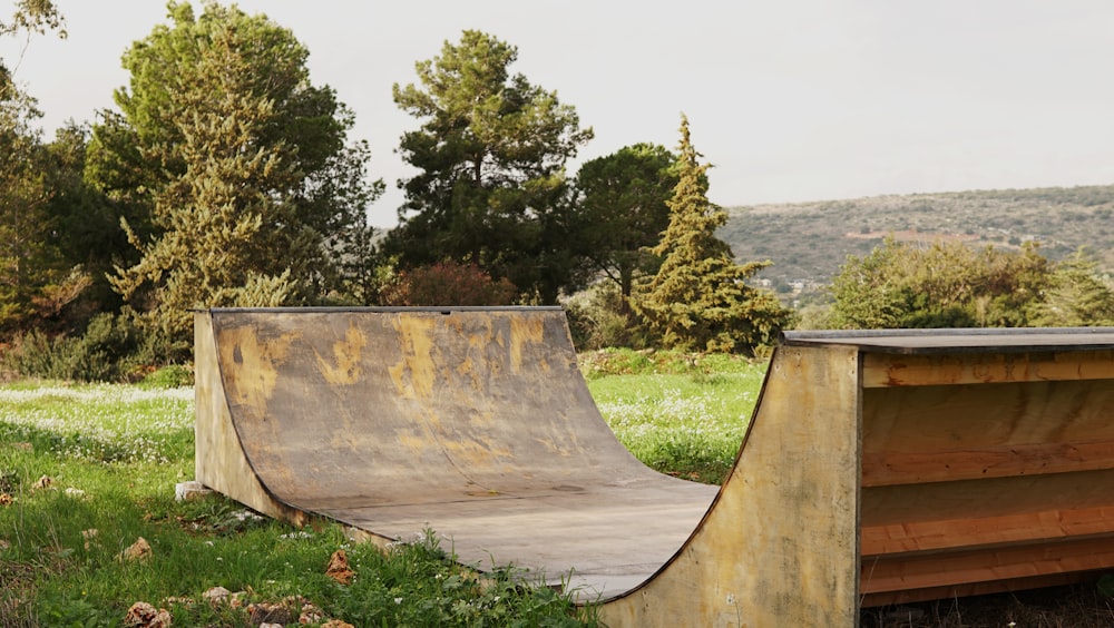 brown wooden skate ramp near green leaf trees