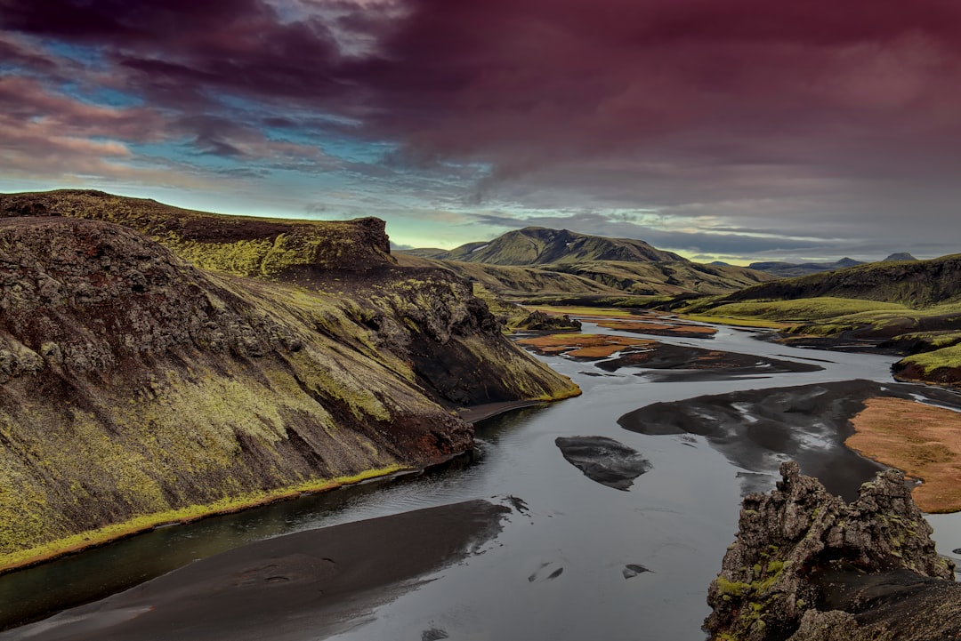 water stream beside mountains