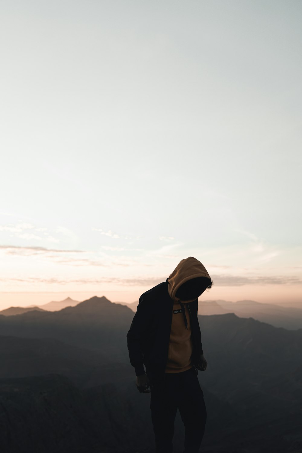 man standing on top of the mountain during daytime