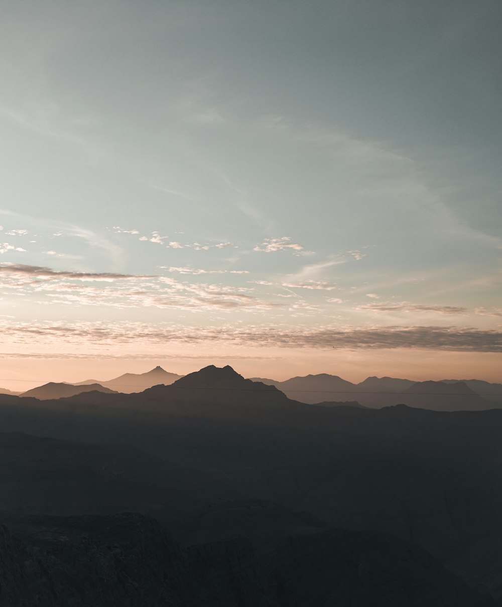 silhouette of mountain under clear blue sky