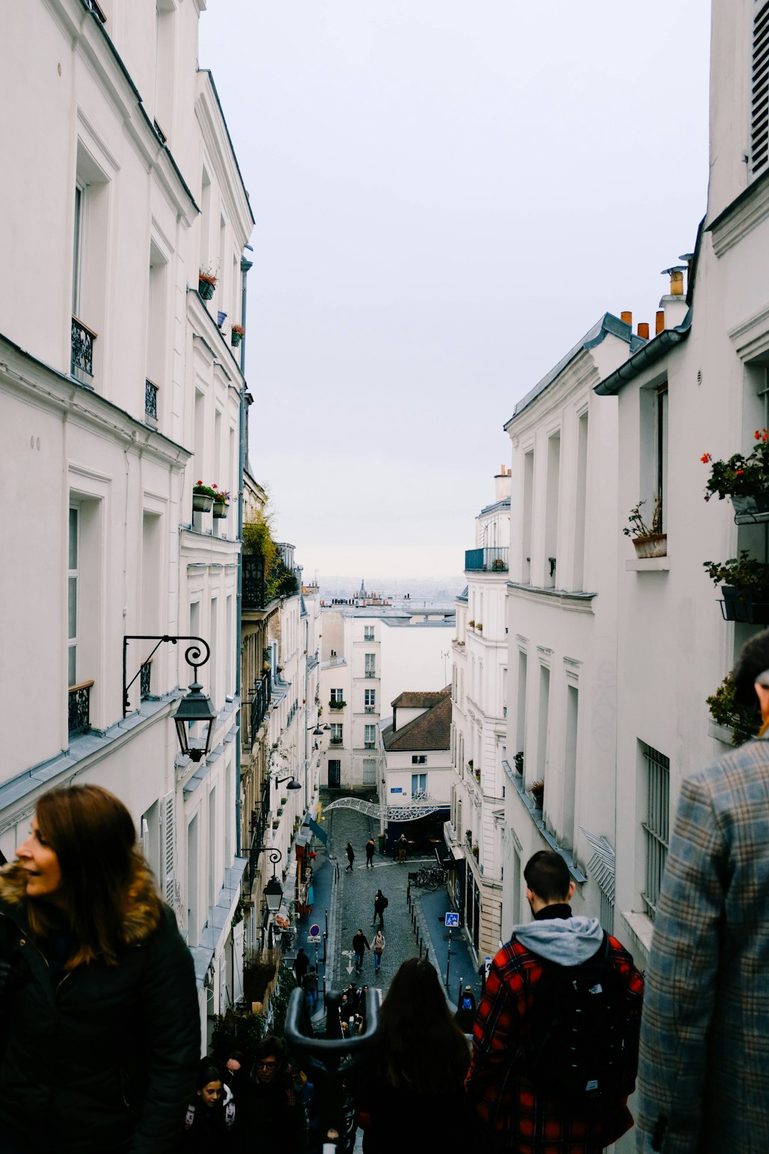 people walking near white houses