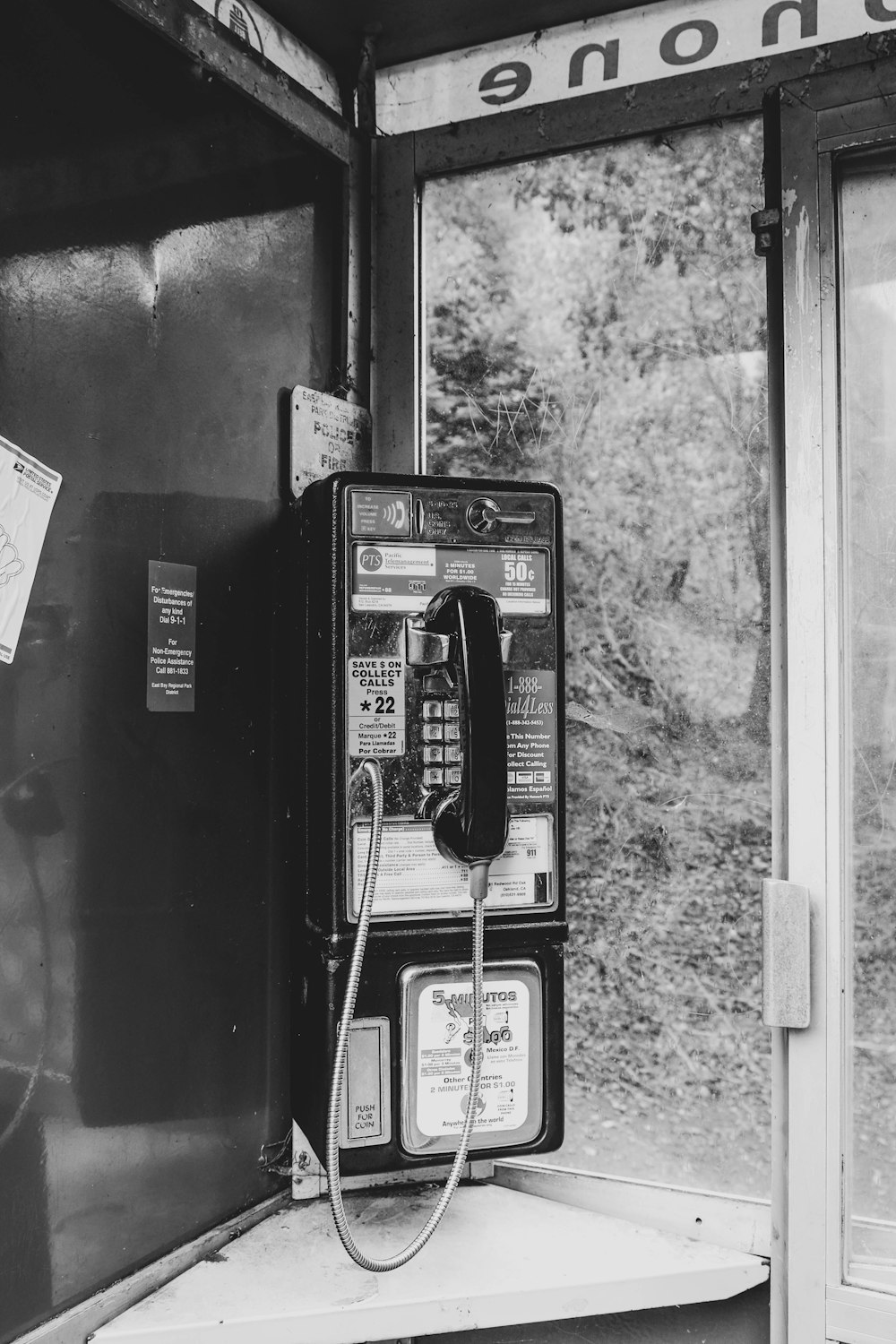 grayscale photography of telephone booth