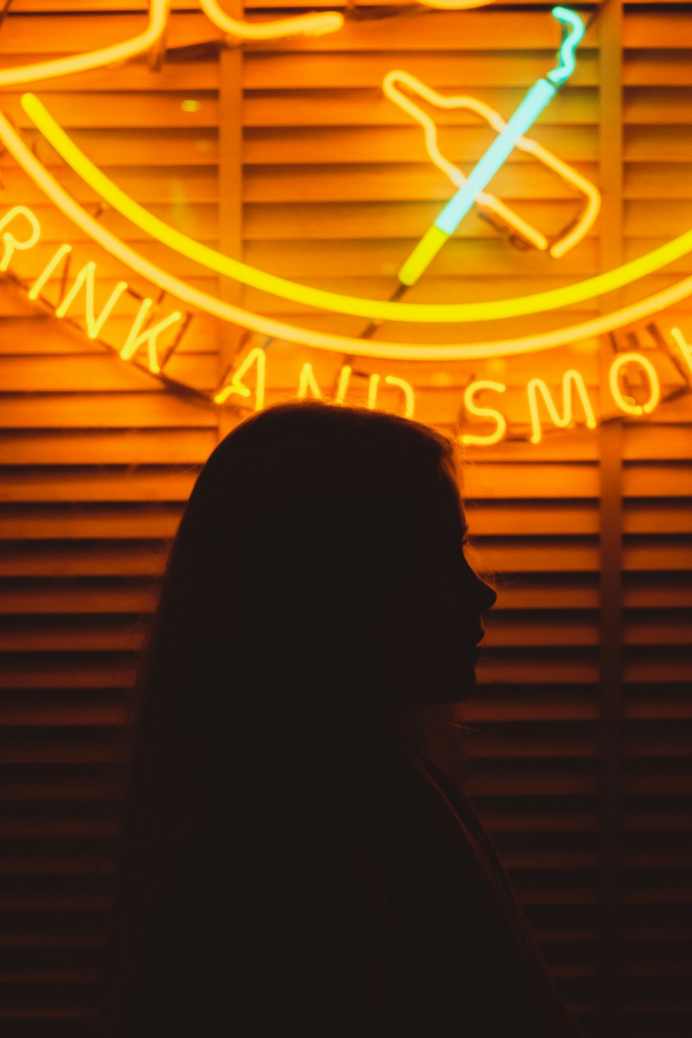woman in front of lighted neon signage