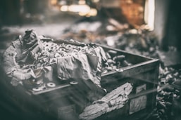 a box filled with lots of trash sitting on top of a pile of rubble