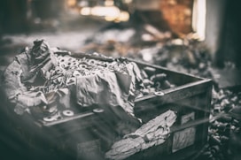 a box filled with lots of trash sitting on top of a pile of rubble